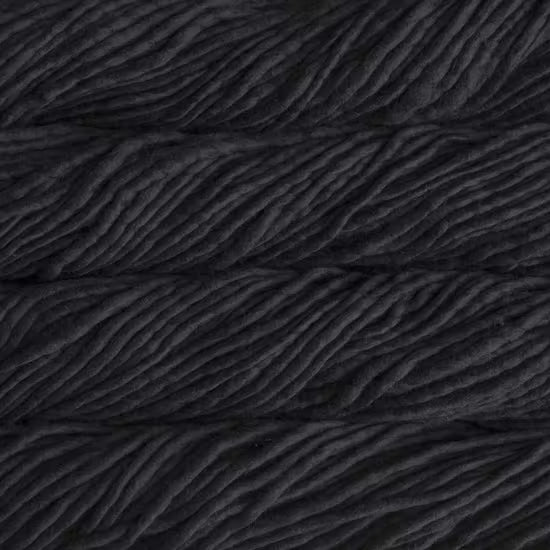 A close-up image of skeins of Malabrigo Rasta yarn in black color, displaying the texture and color variation.