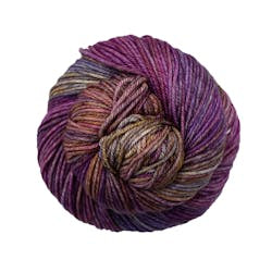 A close up of a skein of Malabrigo Rios worsted weight yarn in purple, orange, yellow, and blue colors