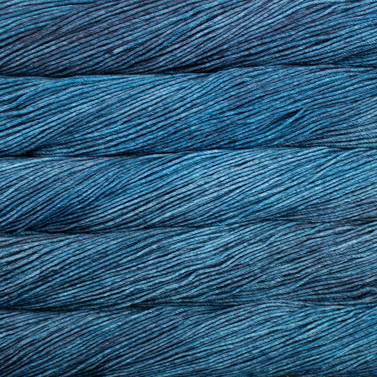 A close up of skeins of Malabrigo Rios worsted weight yarn in dusty blue color