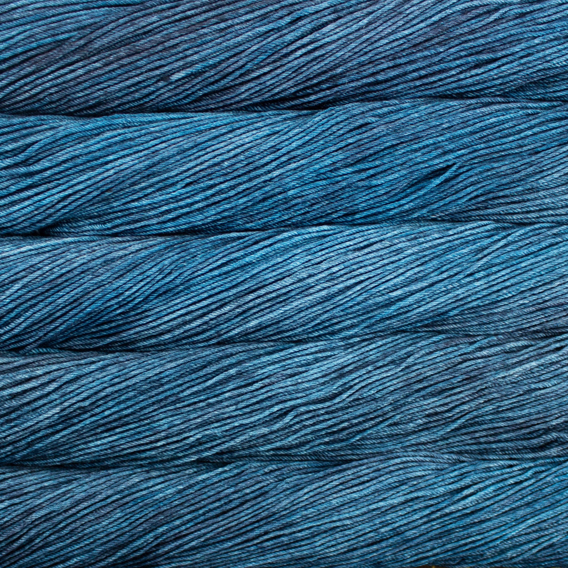 A close up of skeins of Malabrigo Rios worsted weight yarn in dusty blue color