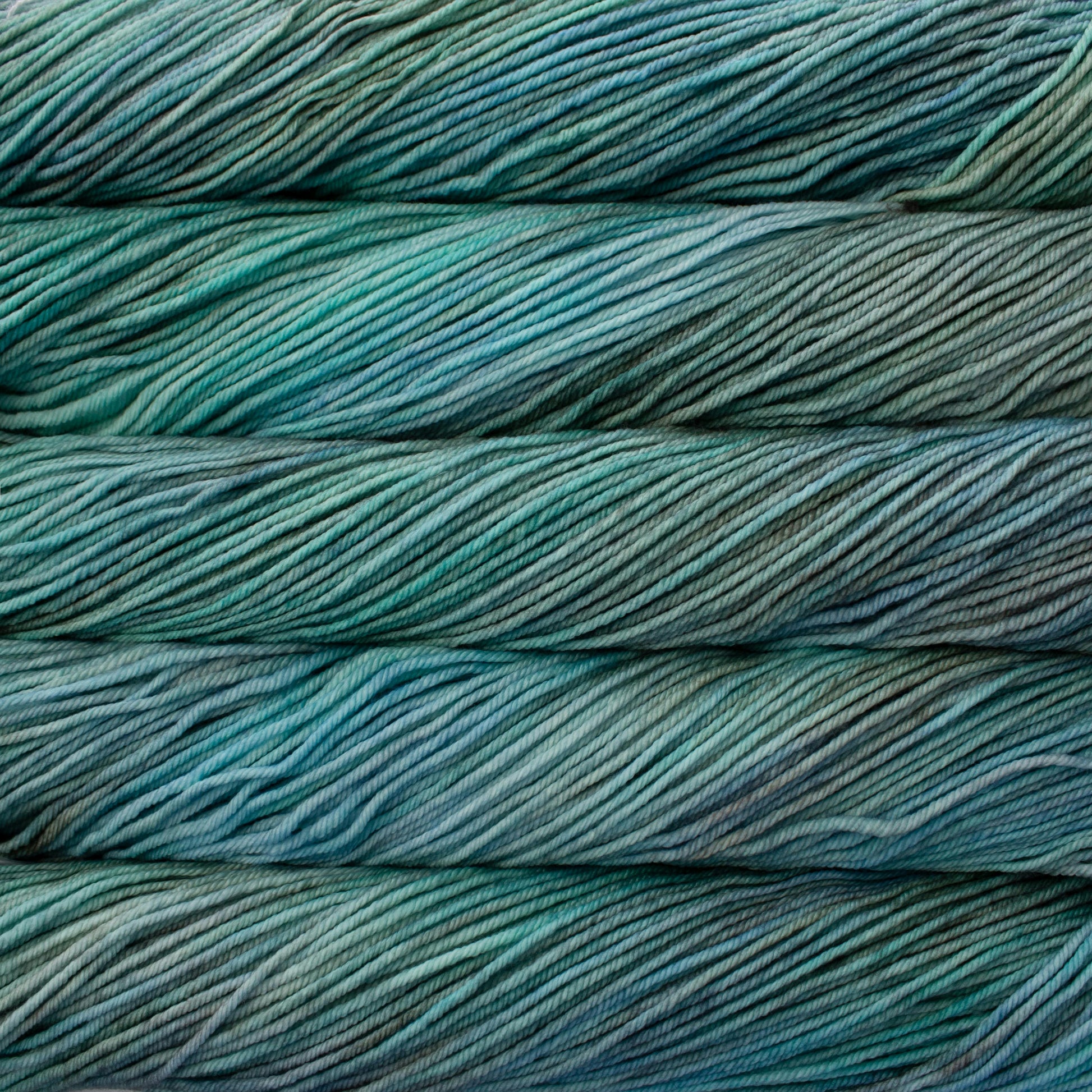 A close up of skeins of Malabrigo Rios worsted weight yarn in aqua and blue colors