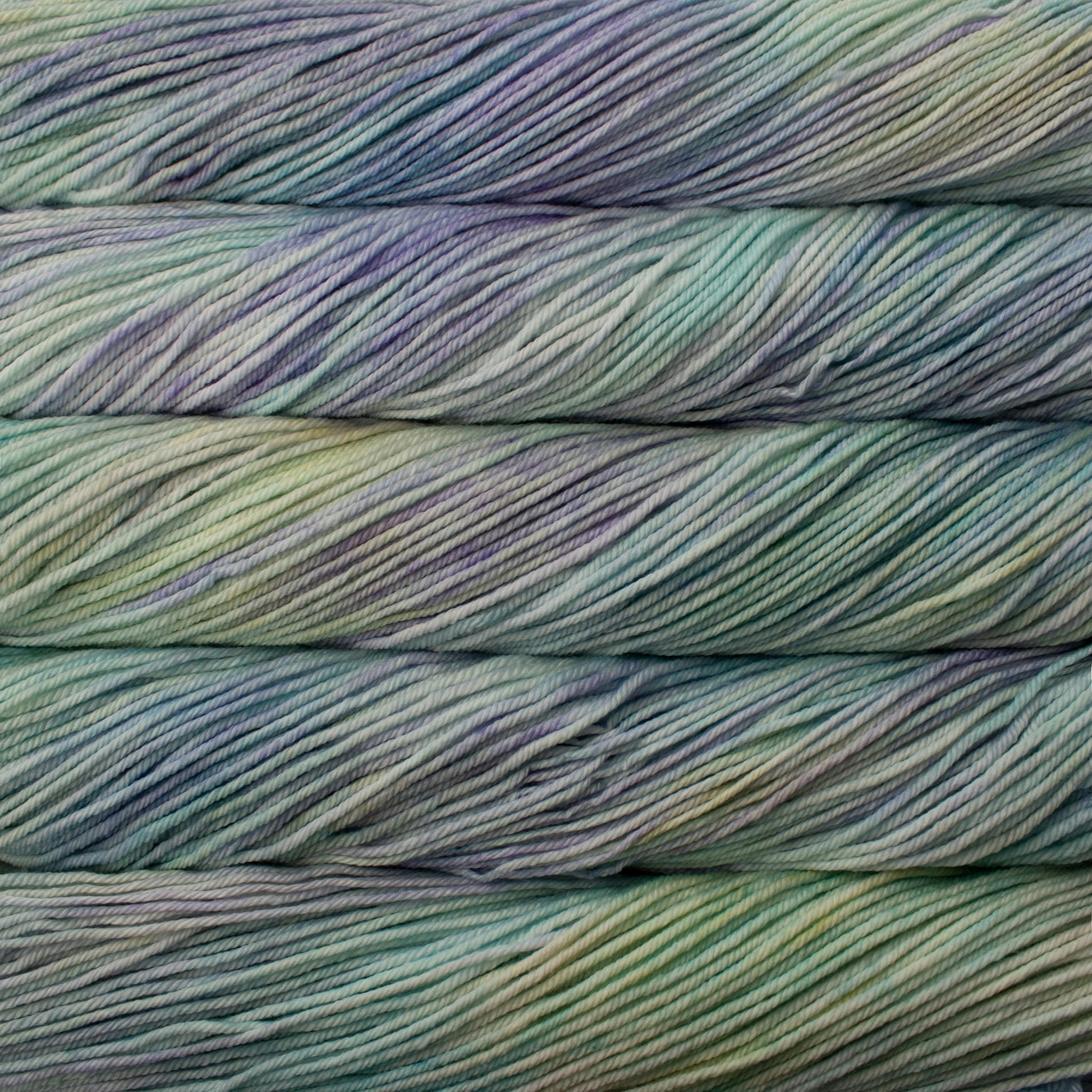 A close up of skeins of Malabrigo Rios worsted weight yarn in green, blue, purple colors