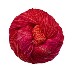 A close up of a skein of Malabrigo Rios worsted weight yarn in red and orange colors