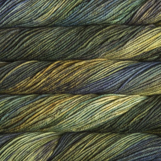 A close up of skeins of Malabrigo Rios worsted weight yarn in yellow, blue, green, and dark grey colors