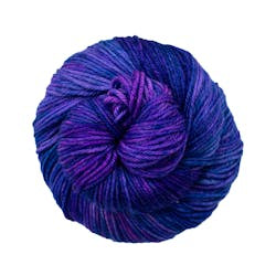 A close up of a skein of Malabrigo Rios worsted weight yarn in deep blue and purple colors