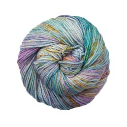 A close up of a skein of Malabrigo Rios worsted weight yarn in blue and purple color with yellow orange speckled color