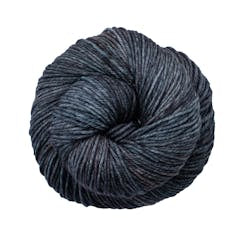 A close up of a skein of Malabrigo Rios worsted weight yarn in dark grey colors