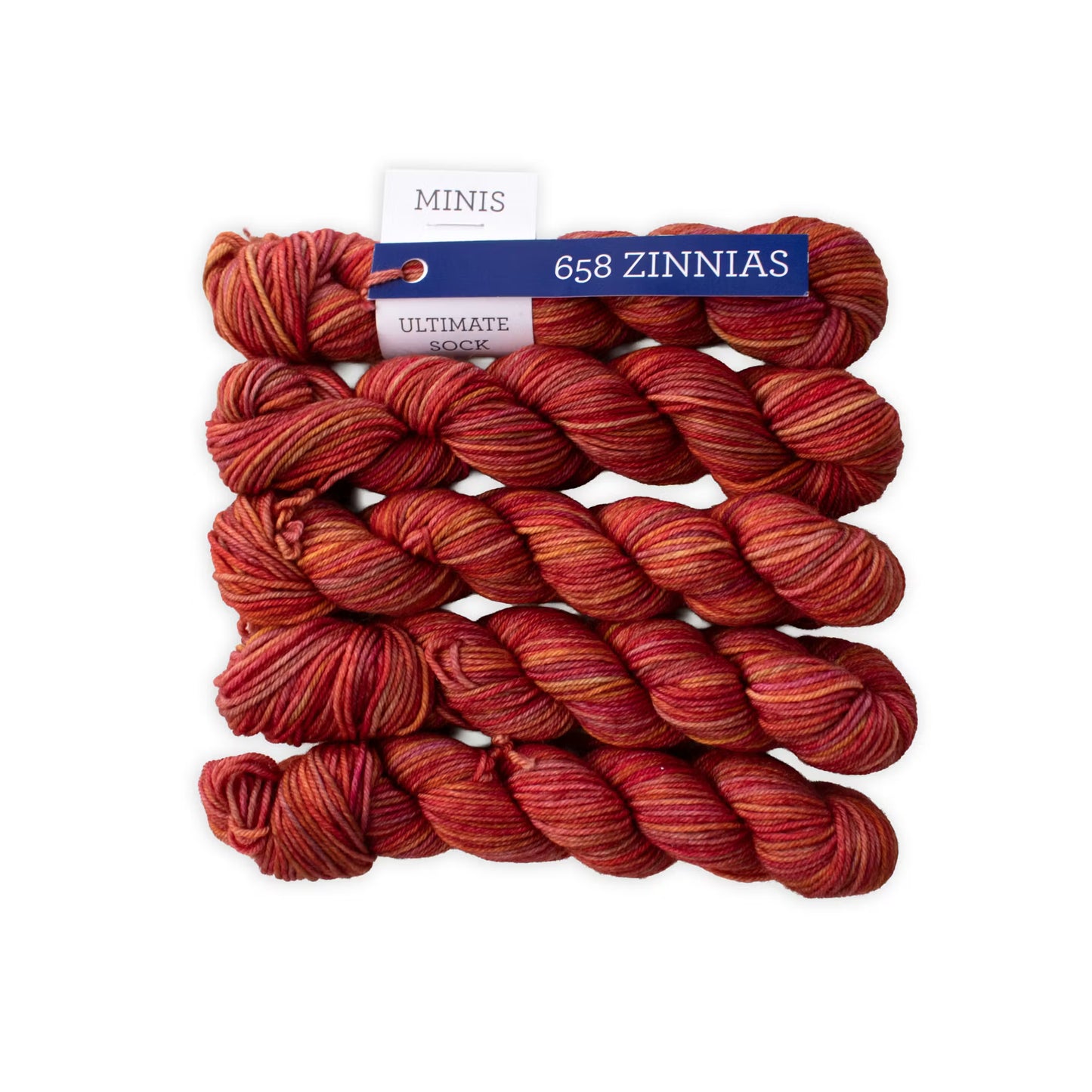 Multiple mini skeins of Malabrigo Ultimate Sock fingering weight yarn in red colors against a white background