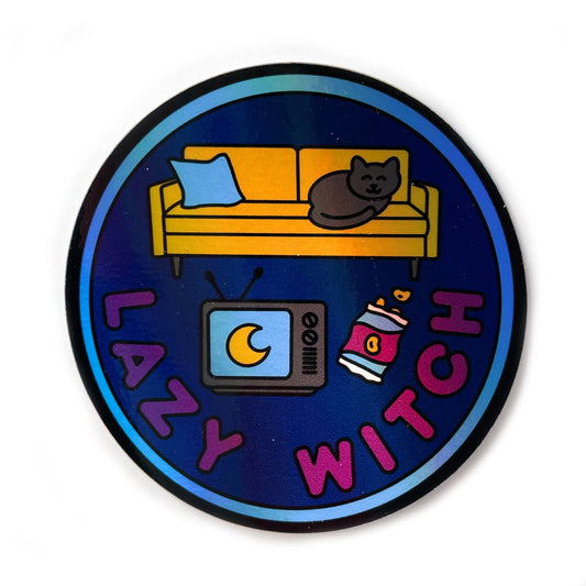 A circular holographic sticker with a blue border, navy background, and maroon words that read "Lazy Witch". It has a vintage TV, bag of chips, and a yellow couch with a black cat on it.