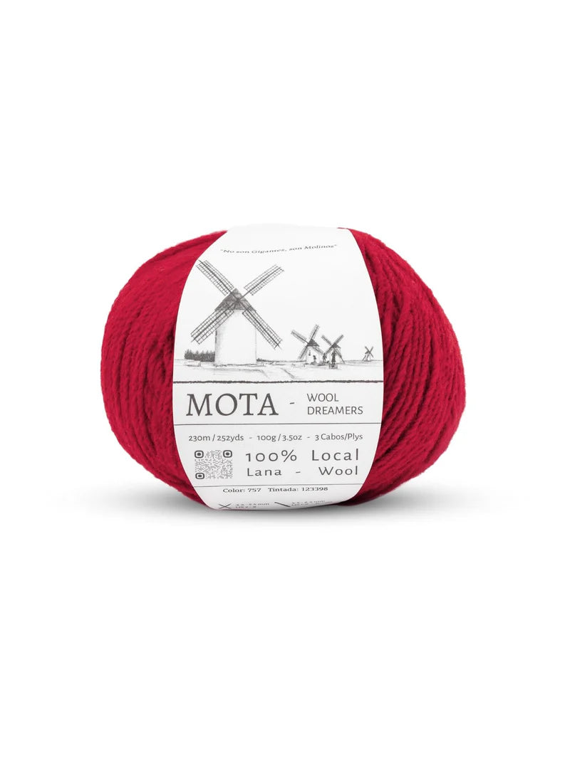 A skein of cherry red yarn on a white background.