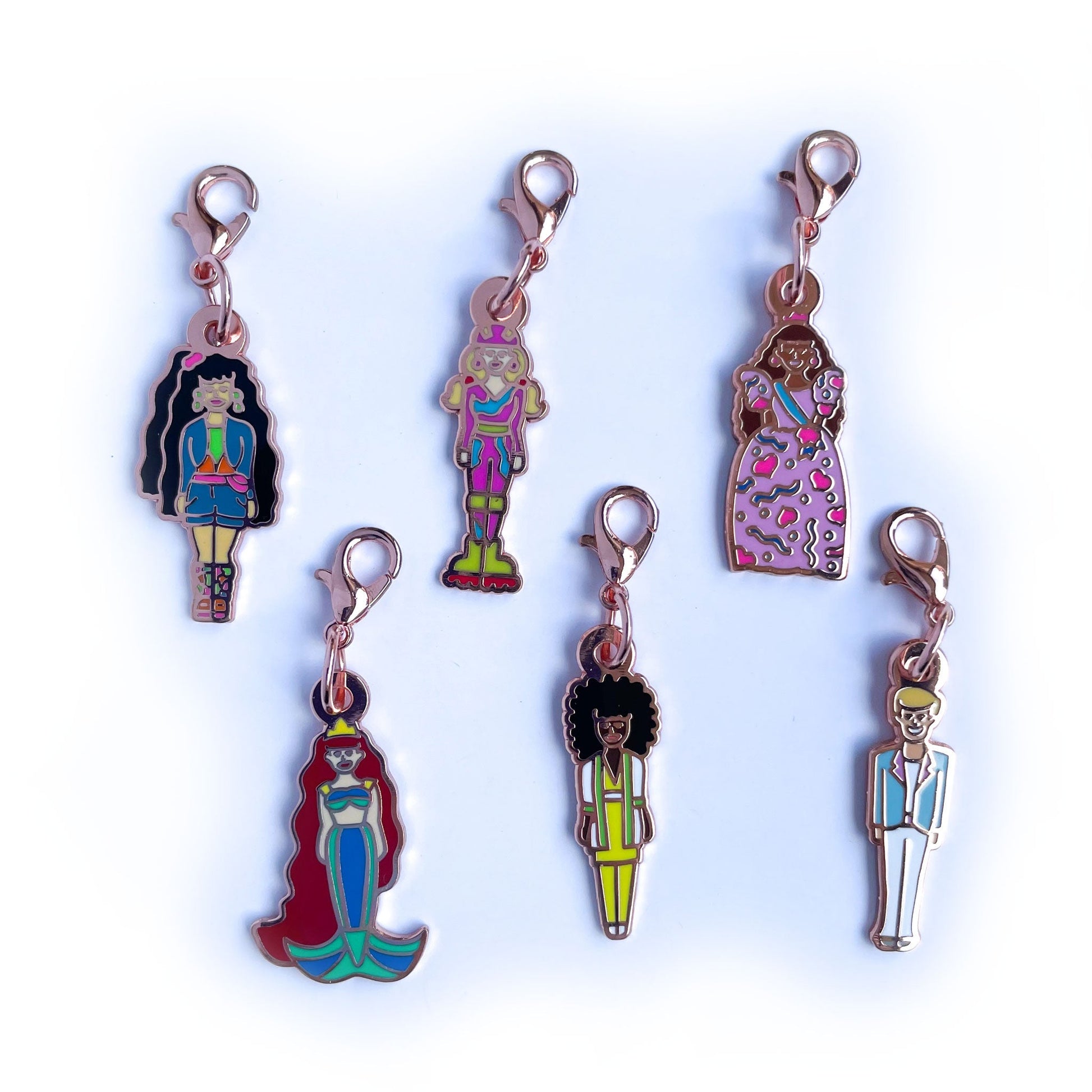 Six doll shaped lobster claw clasp charms 
