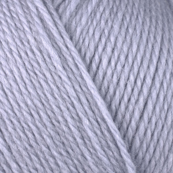 A close-up image of a skein of Berroco Ultra Wool DK weight yarn in a pale purple gray color.