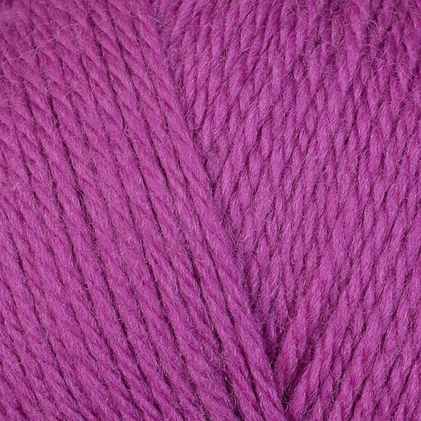 A close-up image of a skein of Berroco Ultra Wool DK weight yarn in a magenta color.