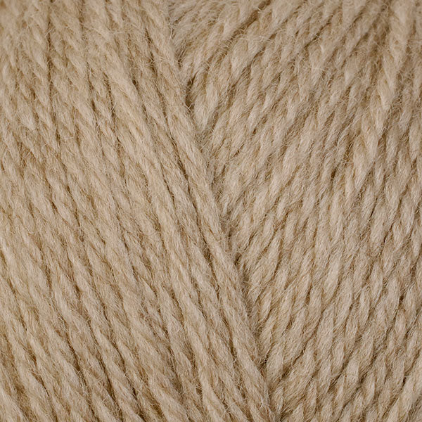 A close-up image of a skein of Berroco Ultra Wool DK weight yarn in a tan color.