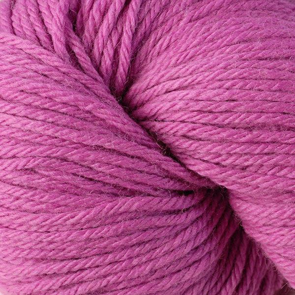 A close up of a skein of Berroco Vintage worsted weight yarn in dusty magenta pink color