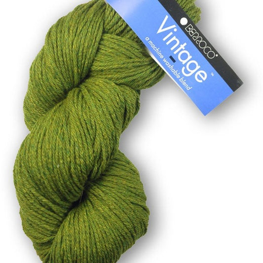 A skein of Berroco Vintage worsted weight yarn in a heathered leaf green color, with the brand label visible.