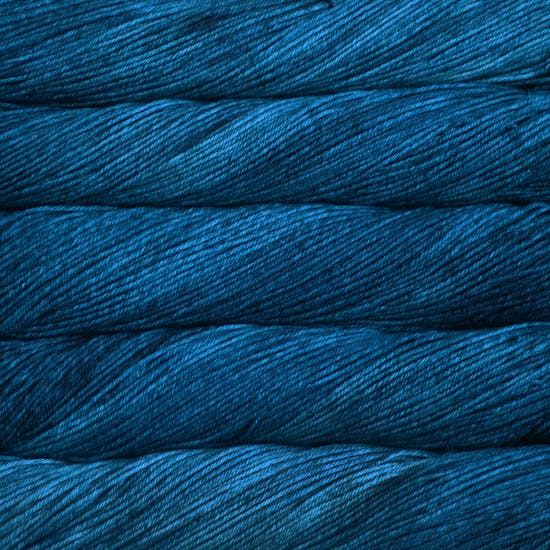 An image of skeins of Malabrigo Arroyo sport weight yarn in vibrant blue shades.