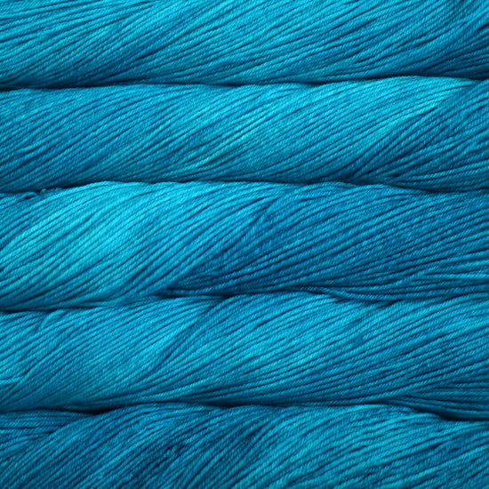 An image of skeins of Malabrigo Arroyo sport weight yarn in vibrant shades of turquoise.