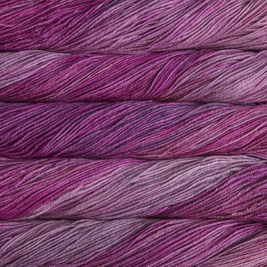 An image of skeins of Malabrigo Arroyo sport weight yarn in light purple and pink shades.