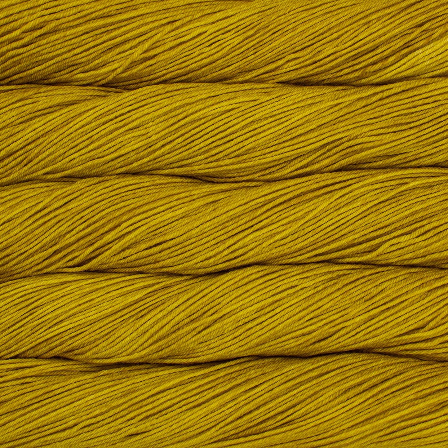 An image of skeins of Malabrigo Arroyo sport weight yarn in vibrant mustard yellow shades.