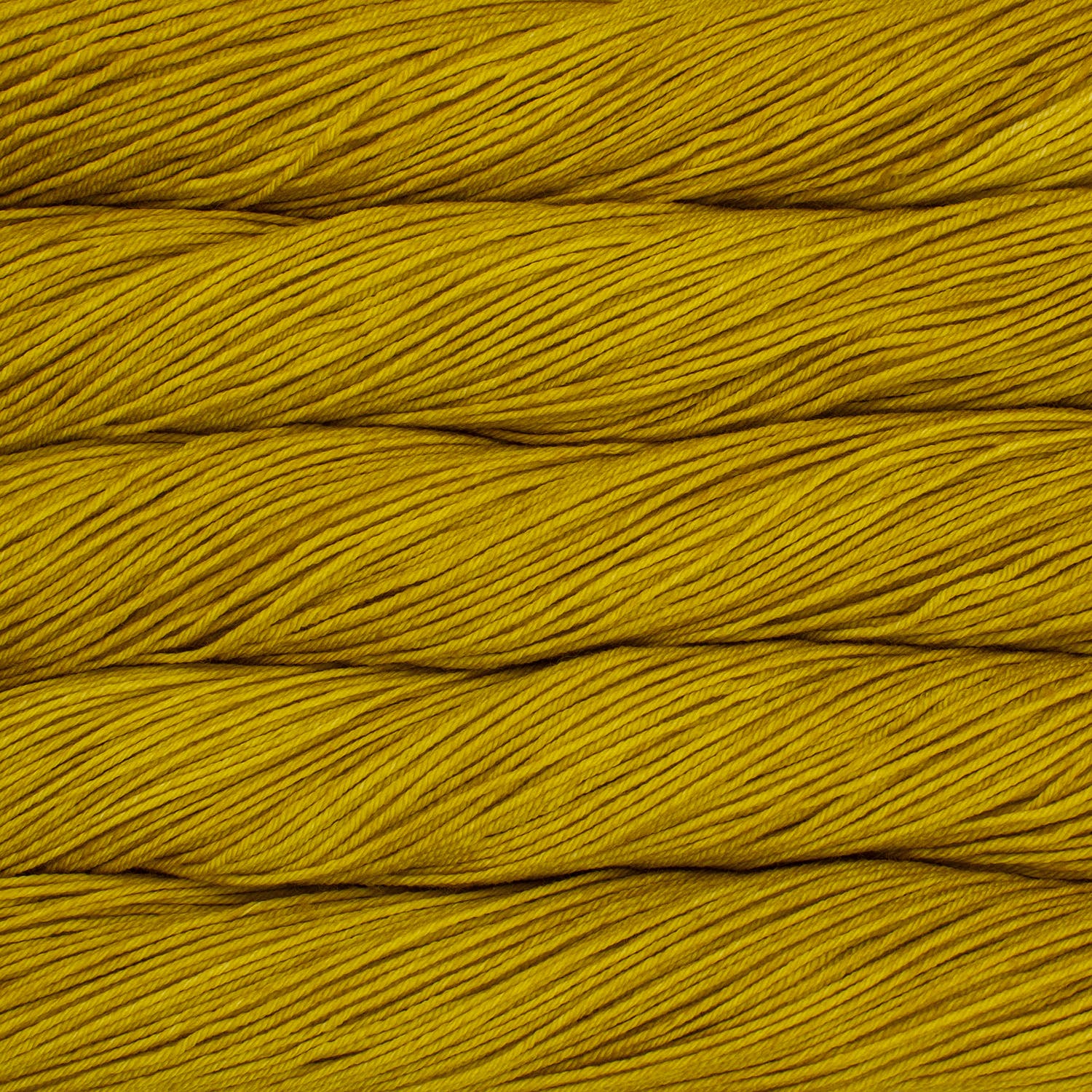 An image of skeins of Malabrigo Arroyo sport weight yarn in vibrant mustard yellow shades.