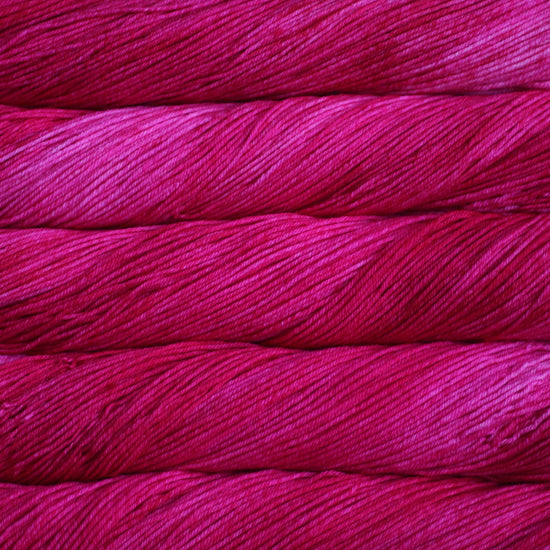 An image of skeins of Malabrigo Arroyo sport weight yarn in hot pink shades.