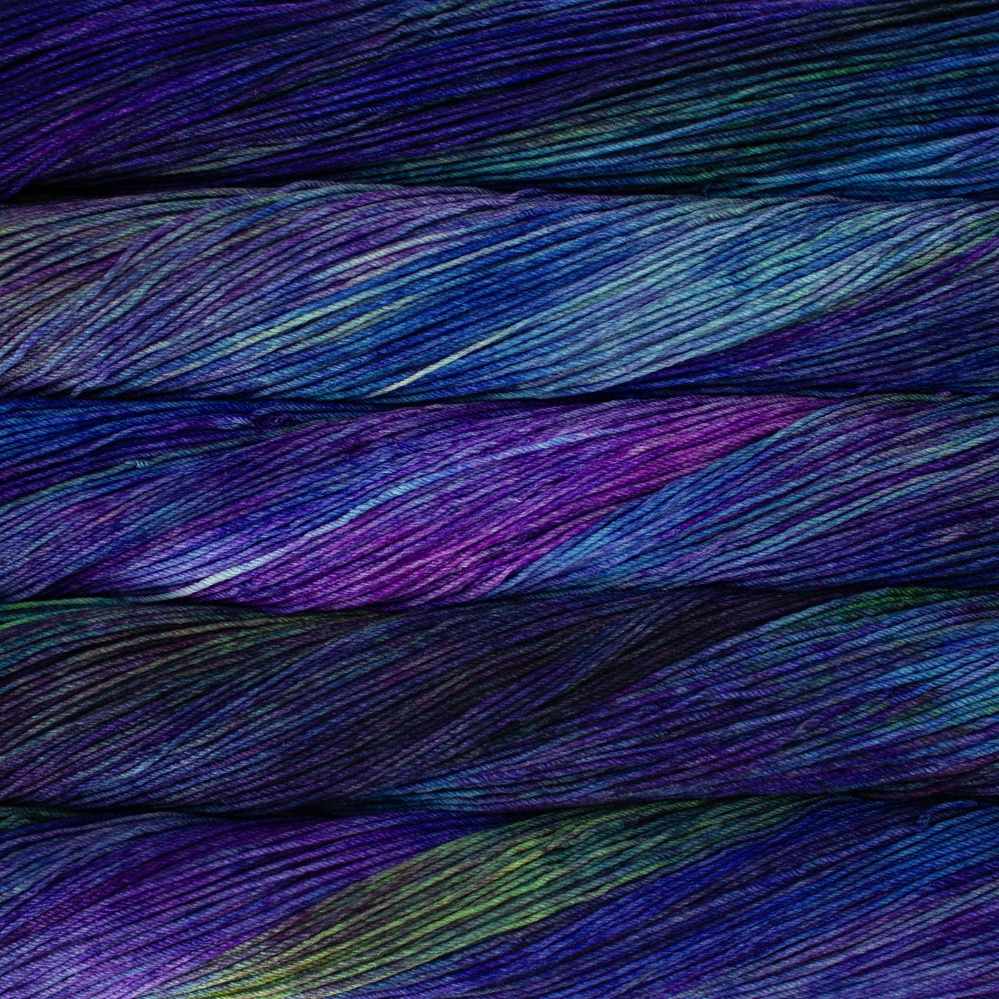 An image of skeins of Malabrigo Arroyo sport weight yarn in deep purple, aqua blue, and green shades.