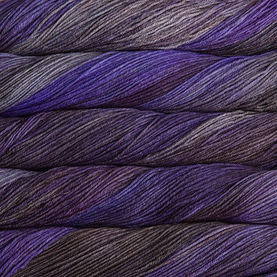 An image of skeins of Malabrigo Arroyo sport weight yarn in deep purple, lavender, and charcoal shades.