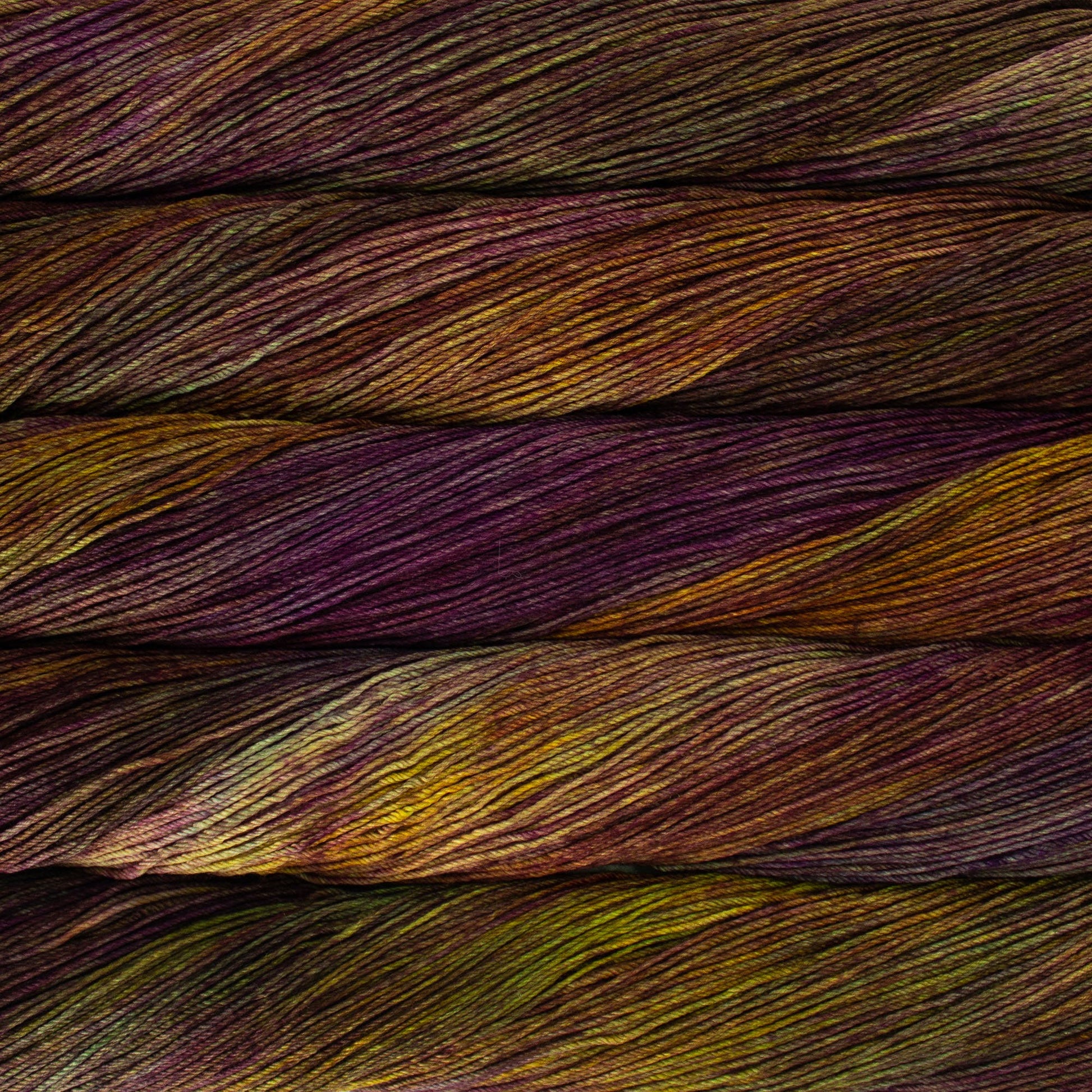 An image of skeins of Malabrigo Arroyo sport weight yarn in yellow, purple, and green shades.