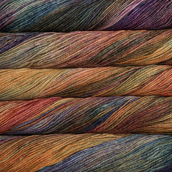 An image of skeins of Malabrigo Arroyo sport weight yarn in shades red, yellow orange, teal, and purple.
