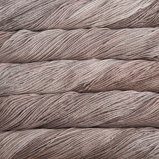 An image of skeins of Malabrigo Arroyo sport weight yarn in taupe shades.