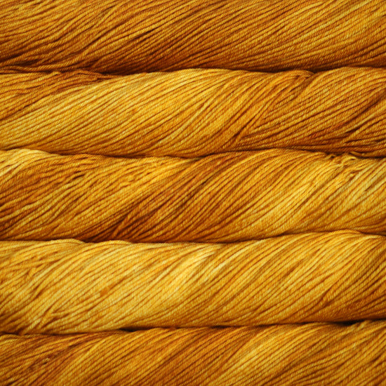 An image of skeins of Malabrigo Arroyo sport weight yarn in vibrant orange and yellow shades.