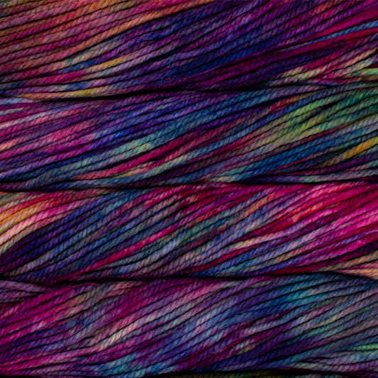 A close up image of skeins of Malabrigo Chunky bulky weight yarn in shades of blue, green, magenta, and purple.