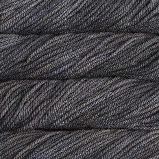 A close up image of skeins of Malabrigo Chunky bulky weight yarn in shades of charcoal black.