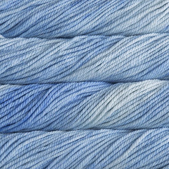 A close up image of skeins of Malabrigo Chunky bulky weight yarn in sky blue shades.