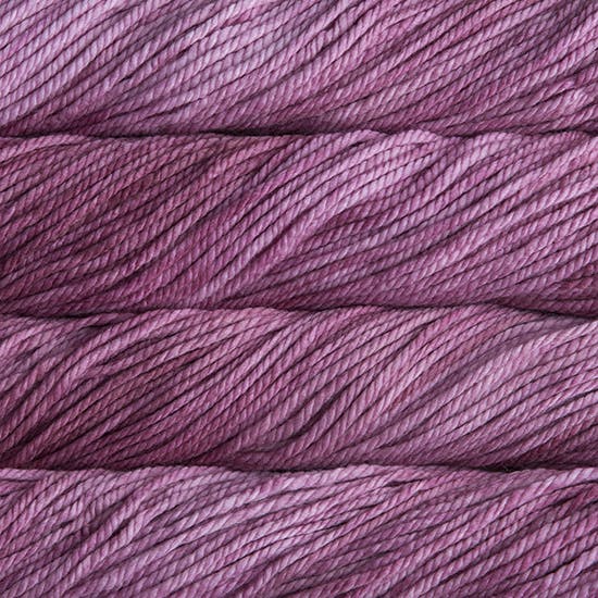 A close up image of skeins of Malabrigo Chunky bulky weight yarn in shades of mauve.