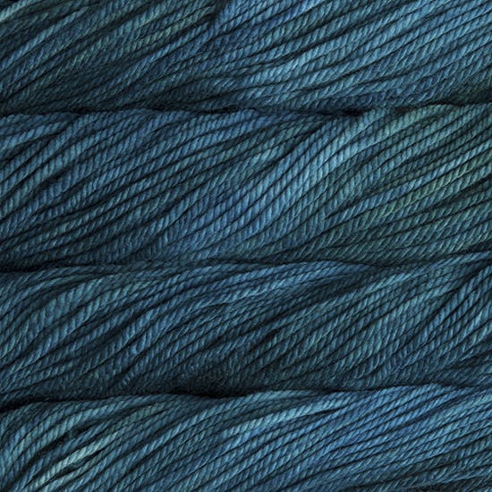A close up image of skeins of Malabrigo Chunky bulky weight yarn in shades of teal.
