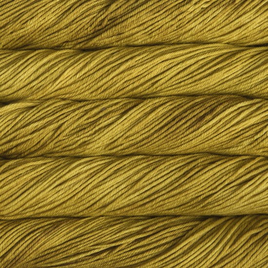 A close up image of skeins of Malabrigo Chunky bulky weight yarn in shades of mustard yellow.