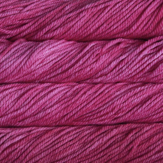 A close up image of skeins of Malabrigo Chunky bulky weight yarn in shades of hot pink.