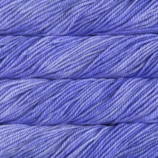 A close up image of skeins of Malabrigo Chunky bulky weight yarn in bright purple shades.