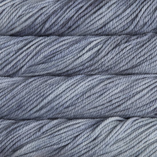 A close up image of skeins of Malabrigo Chunky bulky weight yarn in a pale gray blue shade.
