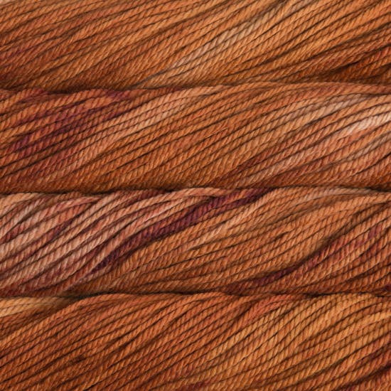 A close up image of skeins of Malabrigo Chunky bulky weight yarn in rust orange shades.