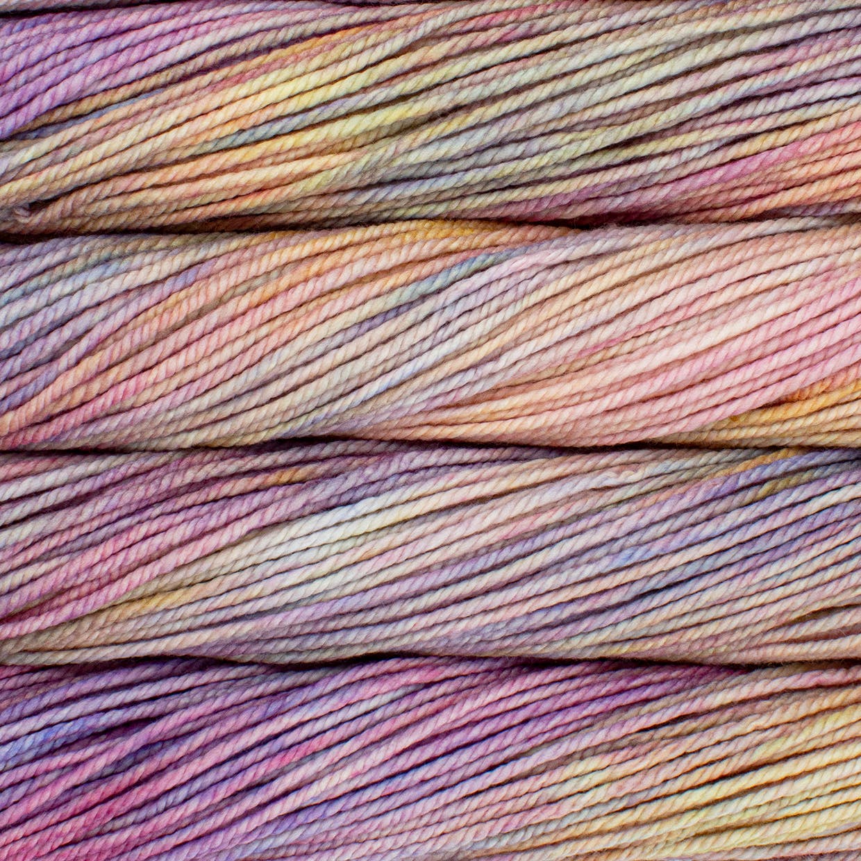 A close up image of skeins of Malabrigo Chunky bulky weight yarn in a pastel rainbow of colors.