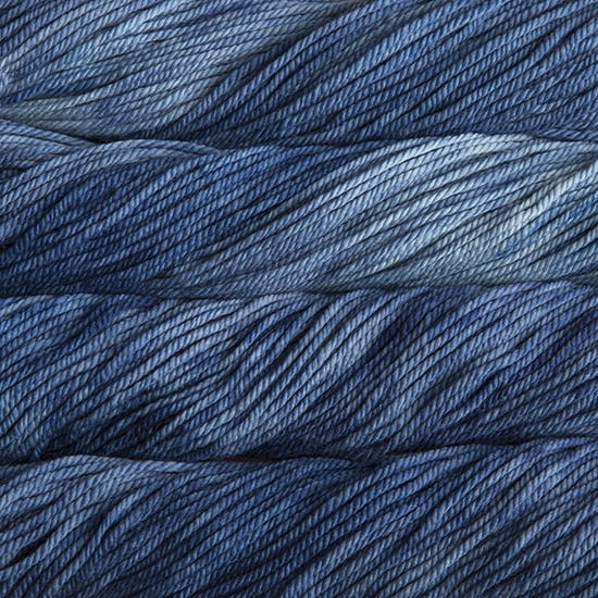 A close up image of skeins of Malabrigo Chunky bulky weight yarn in sky blue and denim blue shades.