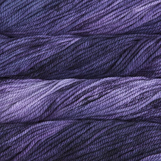 A close up image of skeins of Malabrigo Chunky bulky weight yarn in light purple and deep purple shades.