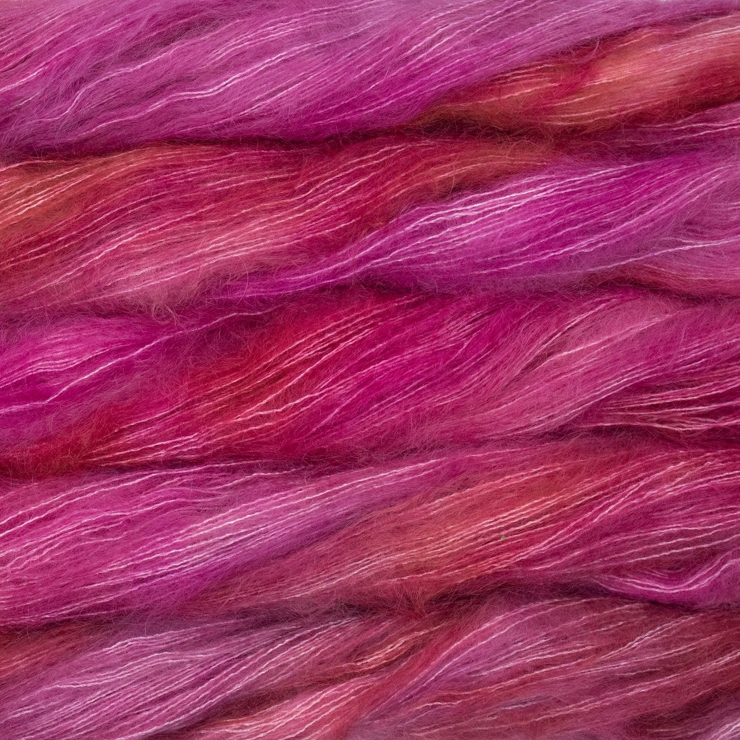 An image of multiple skeins of Malabrigo Mohair yarn in bright pink shades.
