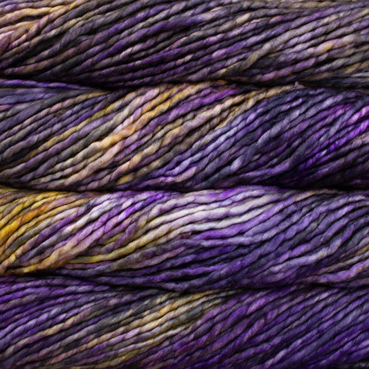 A close-up image of skeins of Malabrigo Rasta yarn in shades yellow and dark purple, displaying the texture and color variation.
