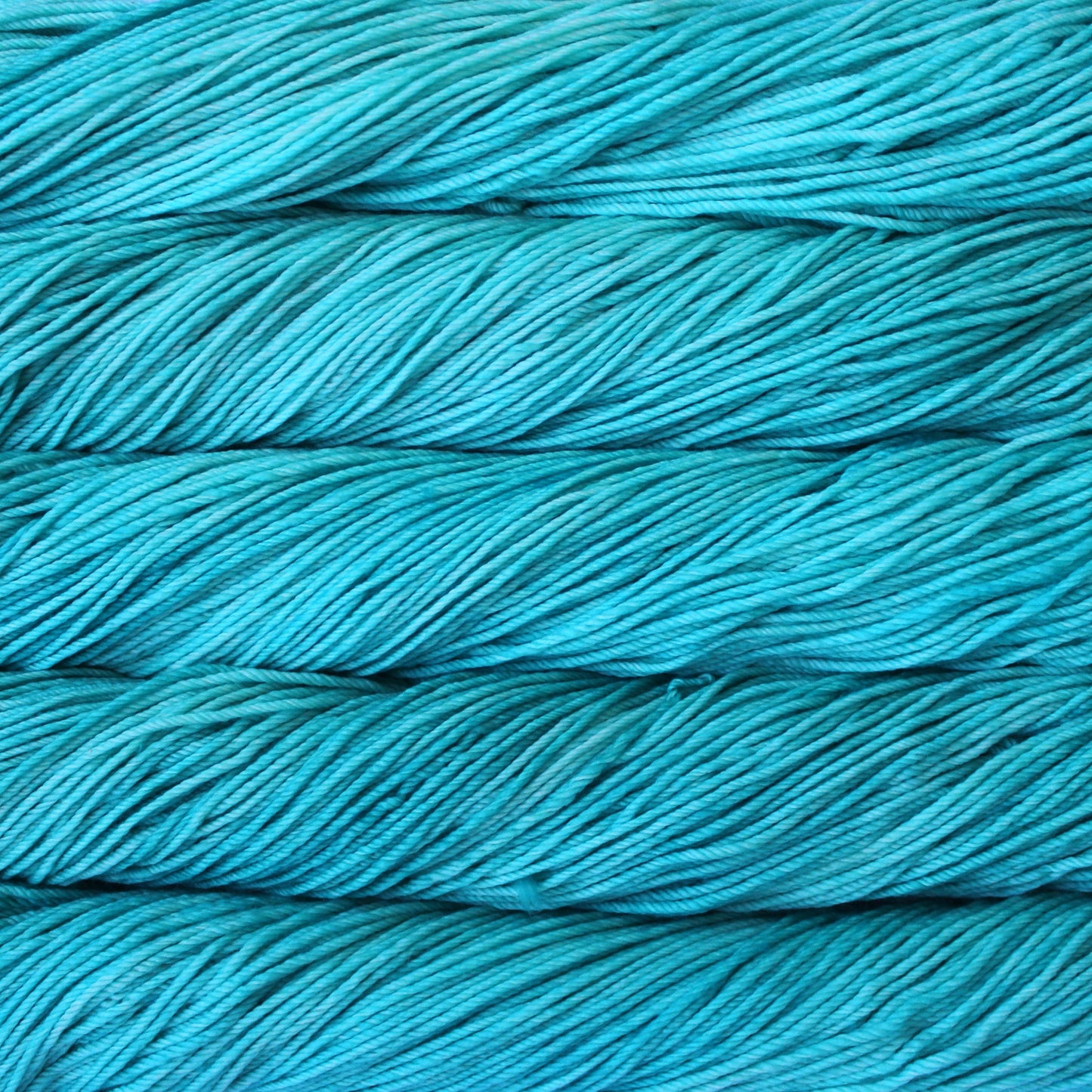 A close up of skeins of Malabrigo Rios worsted weight yarn in aqua blue color