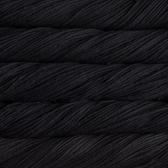 A close up of skeins of Malabrigo Rios worsted weight yarn in black color