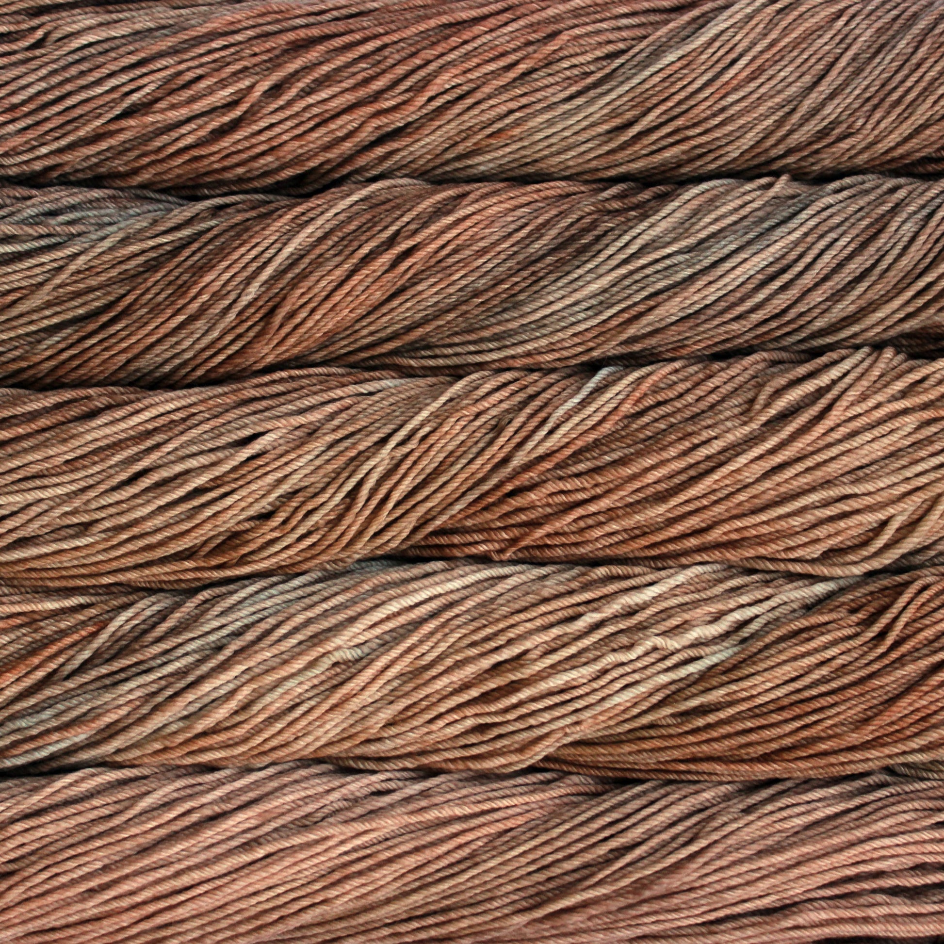 A close up of skeins of Malabrigo Rios worsted weight yarn in tan and beige colors